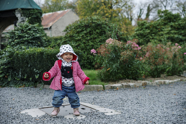 Baby girl walking in the garden, autumn - Фото, зображення