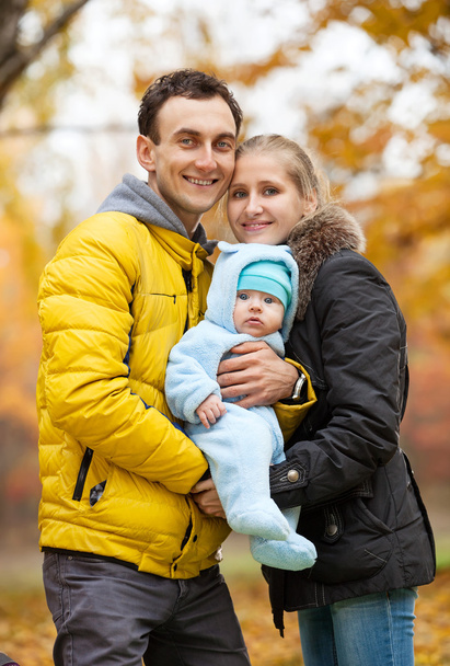 Young couple with baby boy in autumn park - Photo, Image