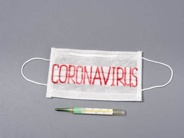 antiviral face mask on a gray background. coronavirus epidemic. - Zdjęcie, obraz