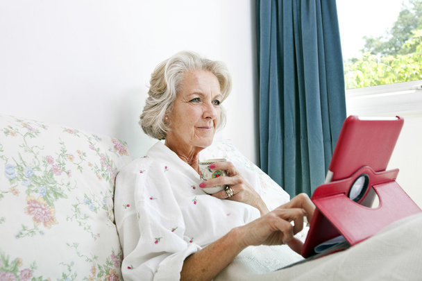 Senior woman using digital tablet - Fotoğraf, Görsel