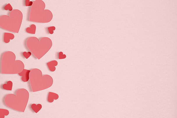 Red hearts on soft pink paper color background. Valentine day concept. - Photo, Image