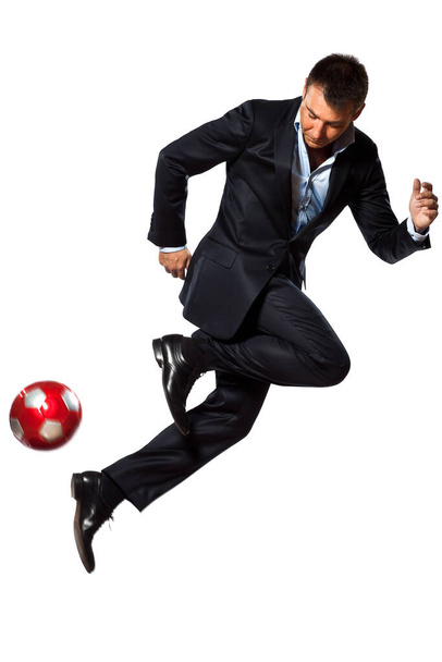 one caucasian business man playing juggling soccer ball in studio isolated on white background - Фото, изображение