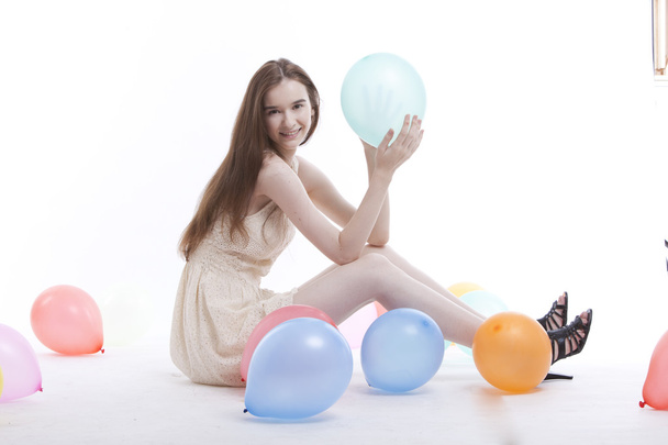 Woman in dress on floor with balloons - Foto, immagini