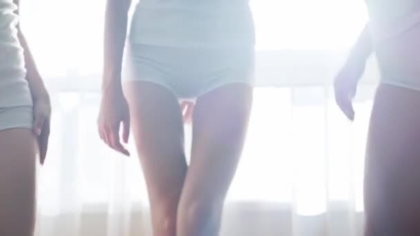 Close up of slender womens body in white sleepwear - Záběry, video