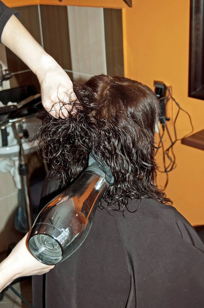 Stylist work on woman hair in salon - Фото, изображение