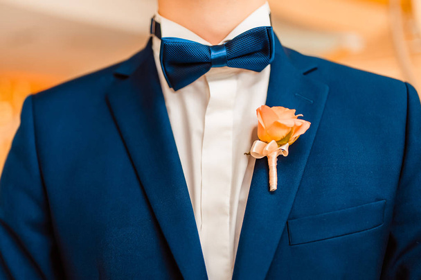 Wedding bouquet a boutonniere on a suit of the groom. - Photo, Image