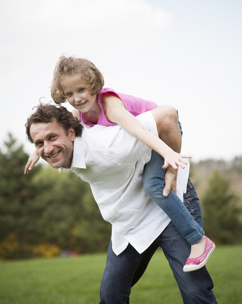 Father giving daughter piggyback - Photo, image