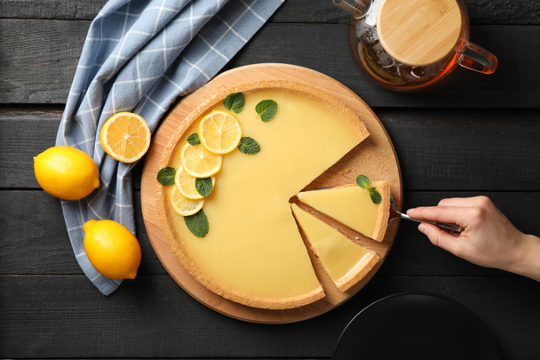 Composition with lemon tart on dark wooden background, top view - Photo, Image
