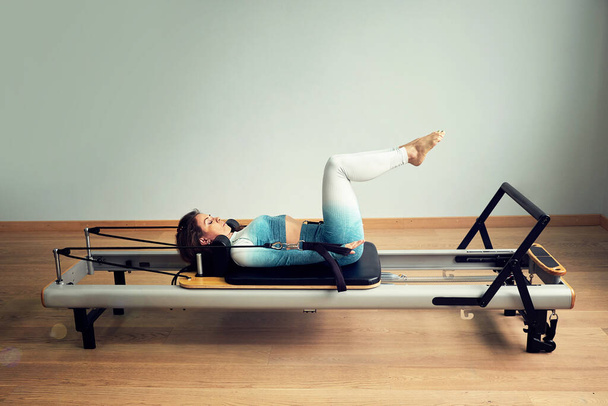 young asian woman pilates stretching sport in reformer bed instructor girl in a studio - Fotografie, Obrázek