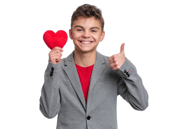 Teen boy with red heart - 写真・画像