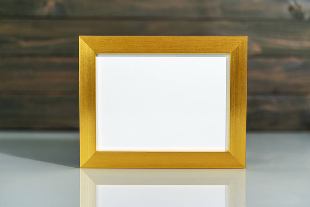 Picture golden frame mock up on table  - Photo, Image