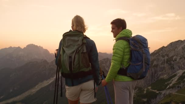 Νεαρό ζευγάρι πεζοπορία στα εκπληκτικά βουνά κόλλα πέντε το ηλιοβασίλεμα. - Πλάνα, βίντεο