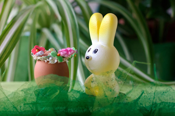 easter celebration concept. toy bunny and decorated easter egg on grass. happy easter and spring  - Photo, Image