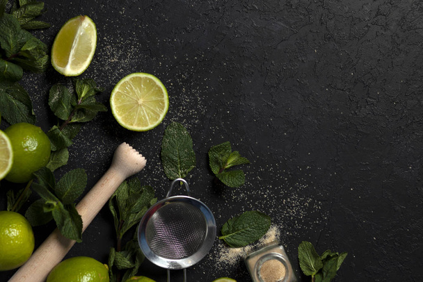 ingredients for making mojito on a dark background, lime, mint, with tools, flat lay for a mojito recipe - Φωτογραφία, εικόνα