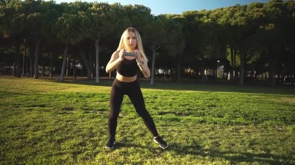 Sport training in city park. Beautiful caucasian fit woman outdoors - Footage, Video