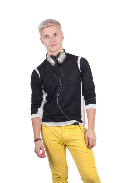 Man in headphones and yellow jeans isolated on white with copy space - Photo, image