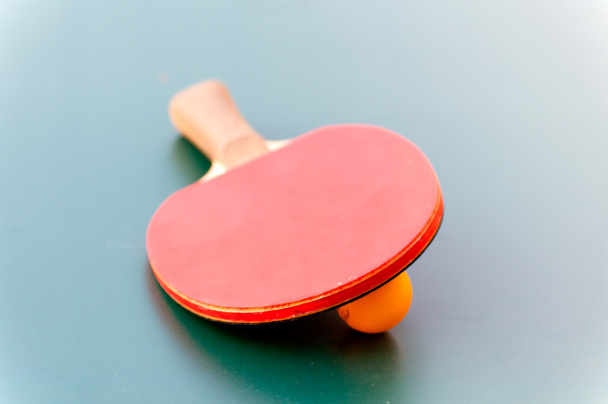 racket for tennis and ball lying on a green table - Photo, Image