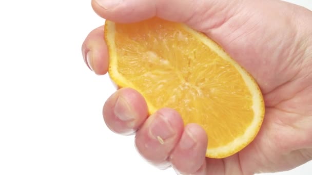 Male hand squeezing an orange - Video, Çekim