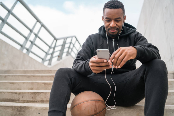 Athletic man using his mobile phone. - Photo, Image