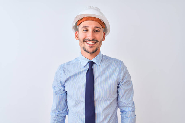 Young business man wearing contractor safety helmet over isolated background with a happy and cool smile on face. Lucky person. - Foto, Imagem