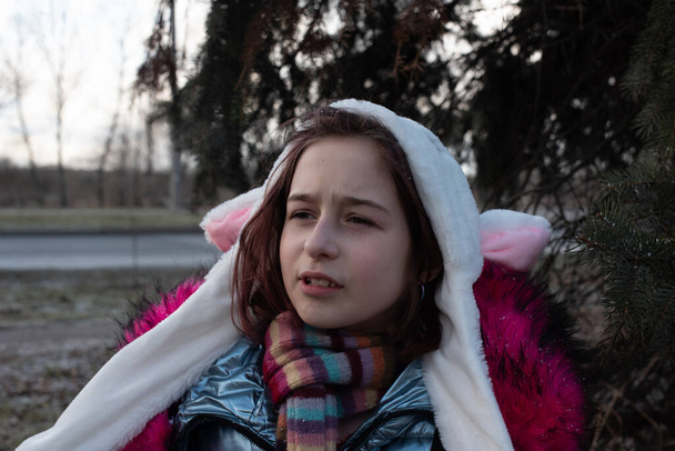 cute little girl in hood with ears. girl in a hat bunny street - Photo, Image