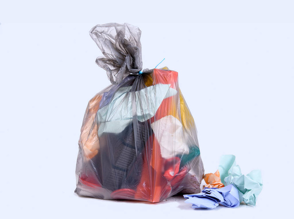 garbage bag with defferent content  in front of light background - Foto, afbeelding