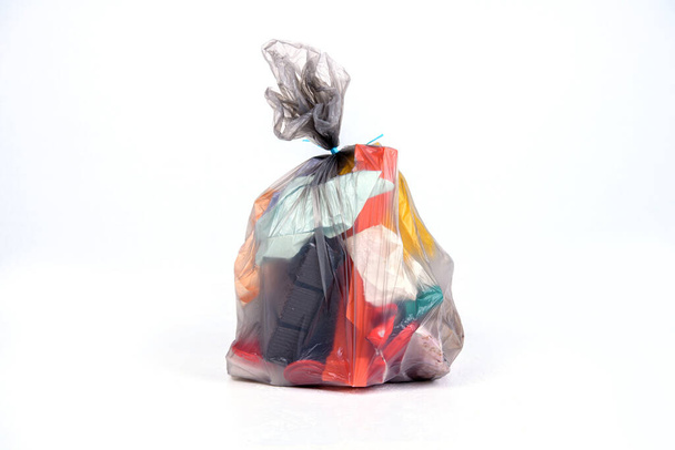 garbage bag with defferent content  in front of light background - Φωτογραφία, εικόνα