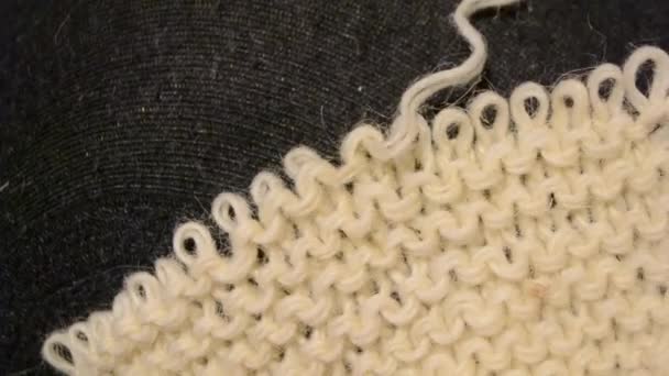 Unraveling the fabric knitted with woolen threads - Footage, Video