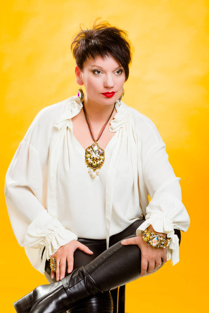 Portrait of a beautiful glamorous woman. Yellow background. - Photo, image