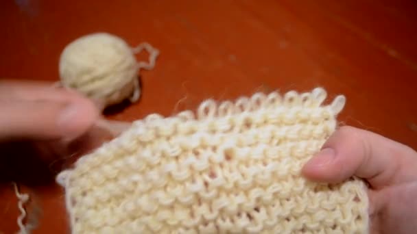 Unraveling the fabric knitted with woolen threads - Footage, Video