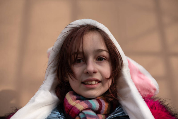 cute little girl in hood with ears. girl in a hat bunny street - Zdjęcie, obraz