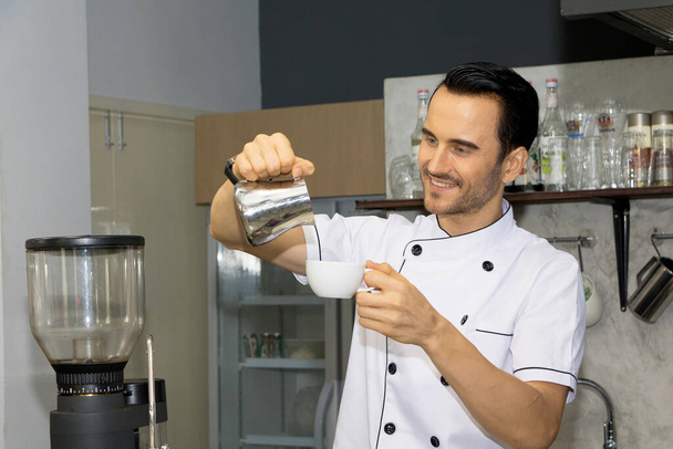 Barista is making coffee in a coffee shop. - Фото, изображение