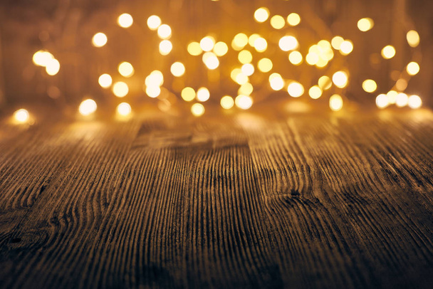 Wooden background with LED lights garland. - Foto, Imagen