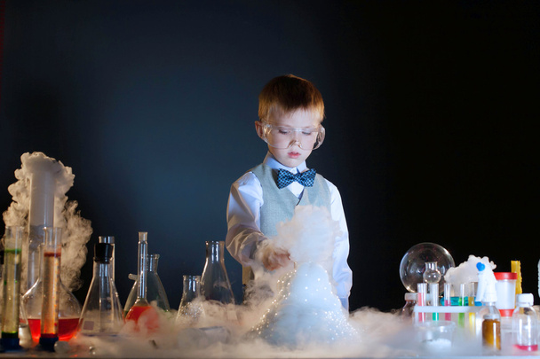 Adorable chemist experimenting with chemicals - Фото, зображення