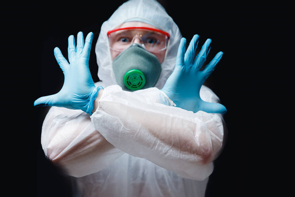 Medic man in white hazmat protective respirator glasses stop epidemic coronavirus. Concept panic evacuation Chinese new Wuhan virus 2019-nCoV - 写真・画像