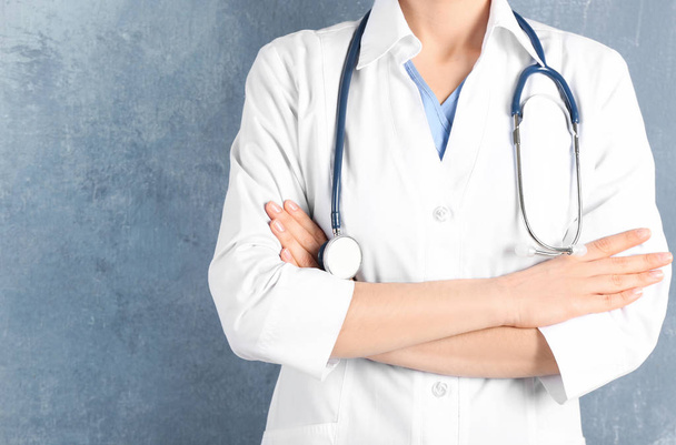 Doctor with stethoscope on blue background, closeup. Medical service - Valokuva, kuva