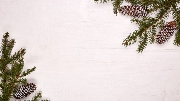 White wooden background with fir branches and cones. New Year and Christmas - Fotografie, Obrázek
