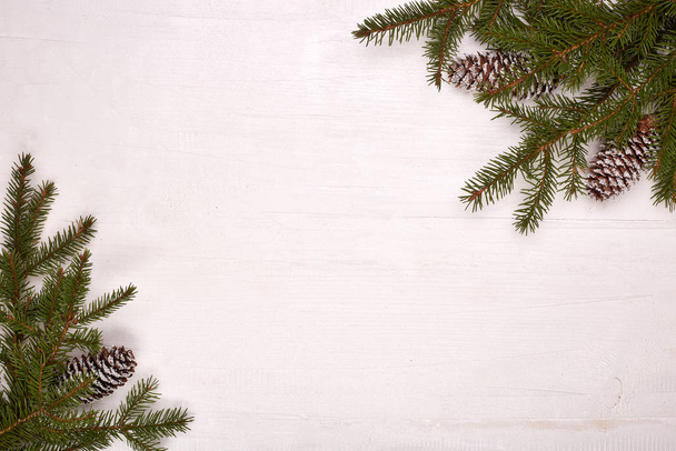 White wooden background with fir branches and cones. New Year and Christmas - Foto, Bild