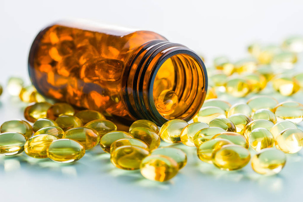 Omega 3 gel capsules. Fish oil pills. Healthy omega-3 in glass bottle. - Fotoğraf, Görsel