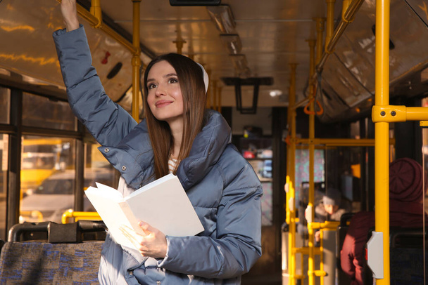 Woman listening to audiobook in trolley bus - Фото, зображення