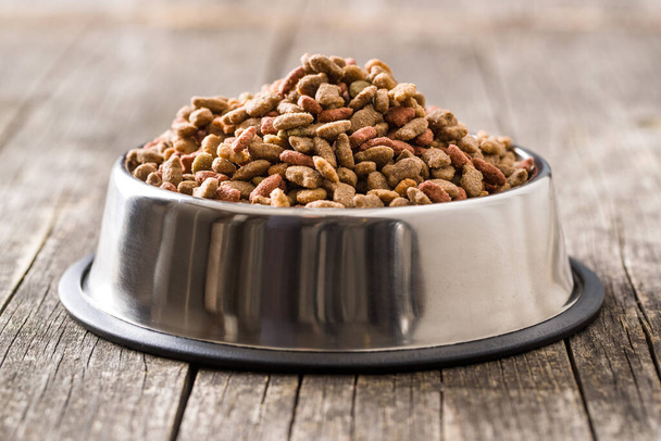 Dry pet food. Dry kibble food in metal bowl. - Foto, Bild