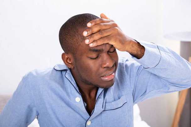 Close-up Of A Young African Man Suffering From Headache - Foto, Bild