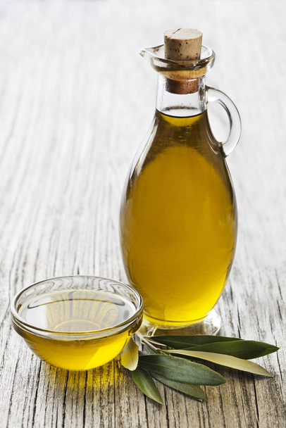 Bottle of Extra virgin healthy Olive oil with leaves close up - Foto, immagini