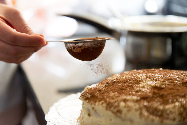 delicious tiramisu cake with chocolate powder on top - Valokuva, kuva