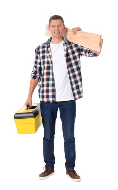 Handsome carpenter with wooden planks and tool box isolated on w - Foto, Imagen