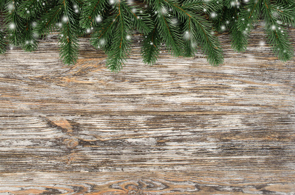 Christmas and New Year wooden background with fir tree in rustic style. Snowy Christmas card. View with copy space. - Foto, Imagem