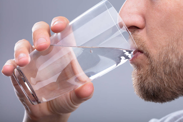 Close-up Of A Man Drinking Glass Of Water - Foto, imagen