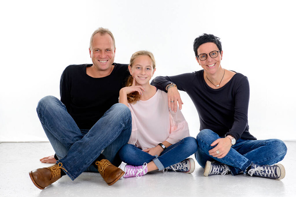 happy family sitting in front of white background - Foto, immagini