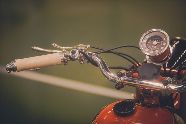 Close up of a vintage motorcycle handlebars and speedometer. - Valokuva, kuva