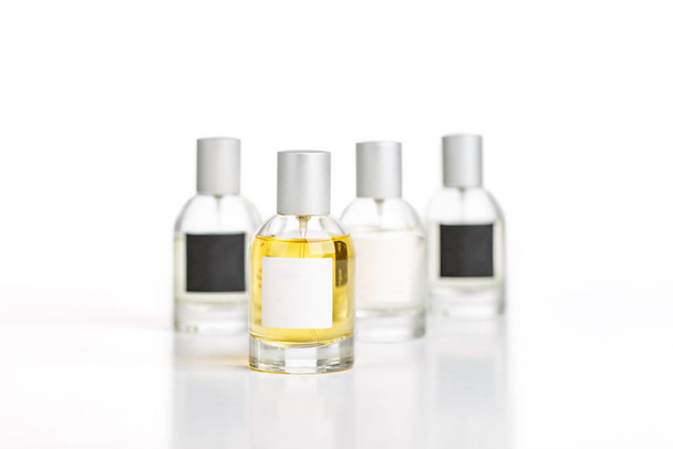 Perfume bottles with different labels on white background - Photo, image